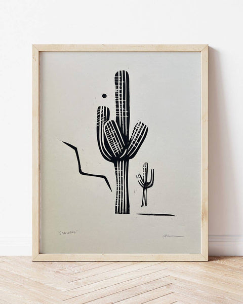 Framed artwork of a black cactus illustration on a light gray background