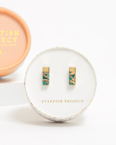 Gold and turquoise earrings in a Starfish Project box on a white background