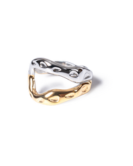 A two-tone wavy ring with a polished silver top band and a gold bottom band, photographed on a clean white background.