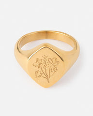 Gold ring with floral engraving on a white background