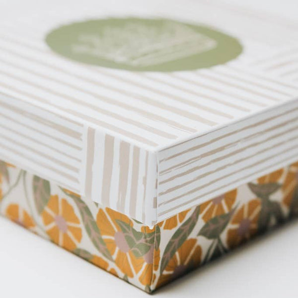 Product packaging with floral design on a white background