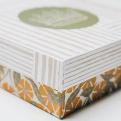 Product packaging with floral design on a white background