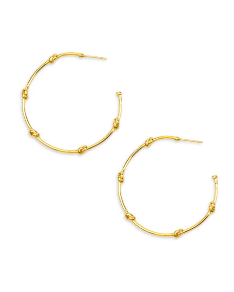 Gold hoop earrings on a white background