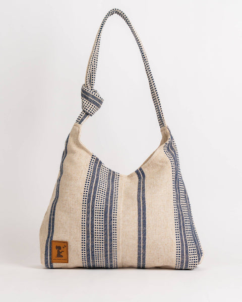 Textured handbag with a strap on a white background