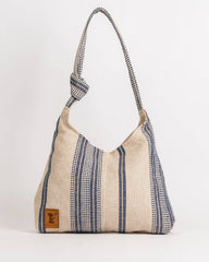 Textured handbag with a strap on a white background