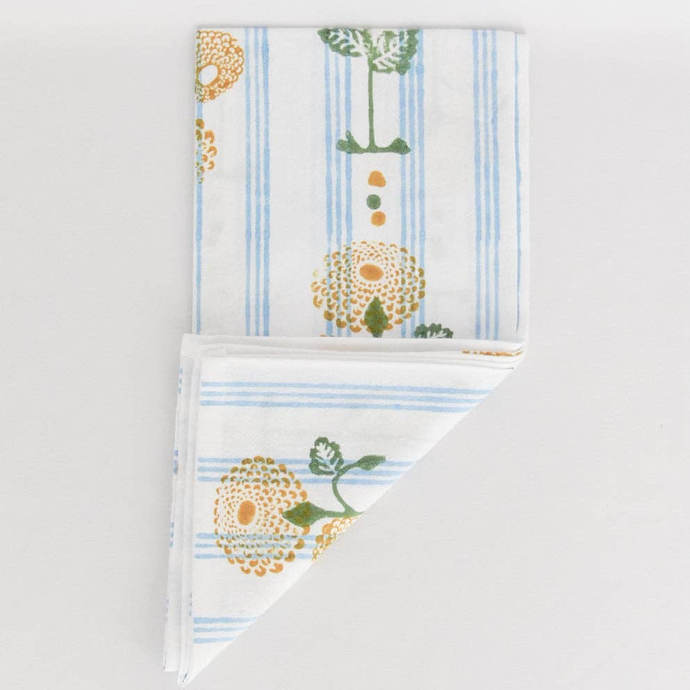 Two folded towels with floral patterns on a light gray background