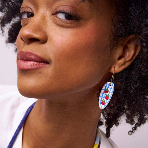 These lightweight ceramic tomato earrings are so playful + chic! Oval ce...
