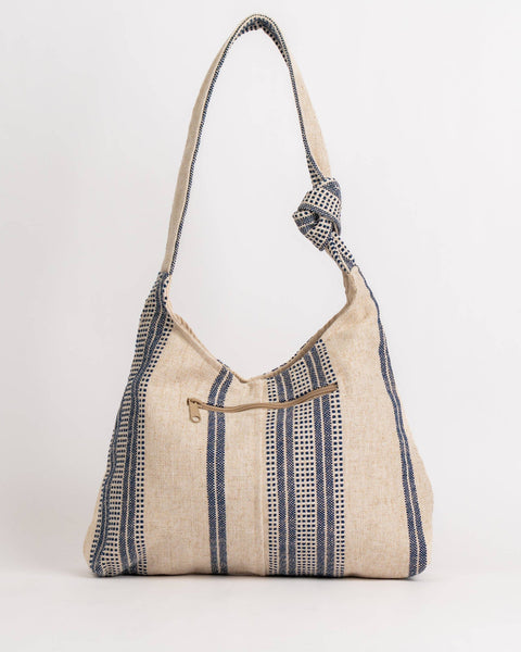 Textured handbag with a strap on a white background