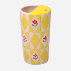 Cylindrical ceramic vase with yellow diamond pattern and red floral design on a white background