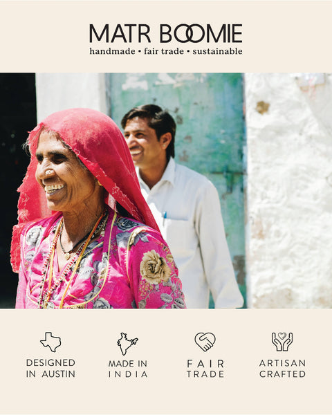 Woman wearing a pink shawl with a man in the background, featuring Matr Boomie branding and product attributes.