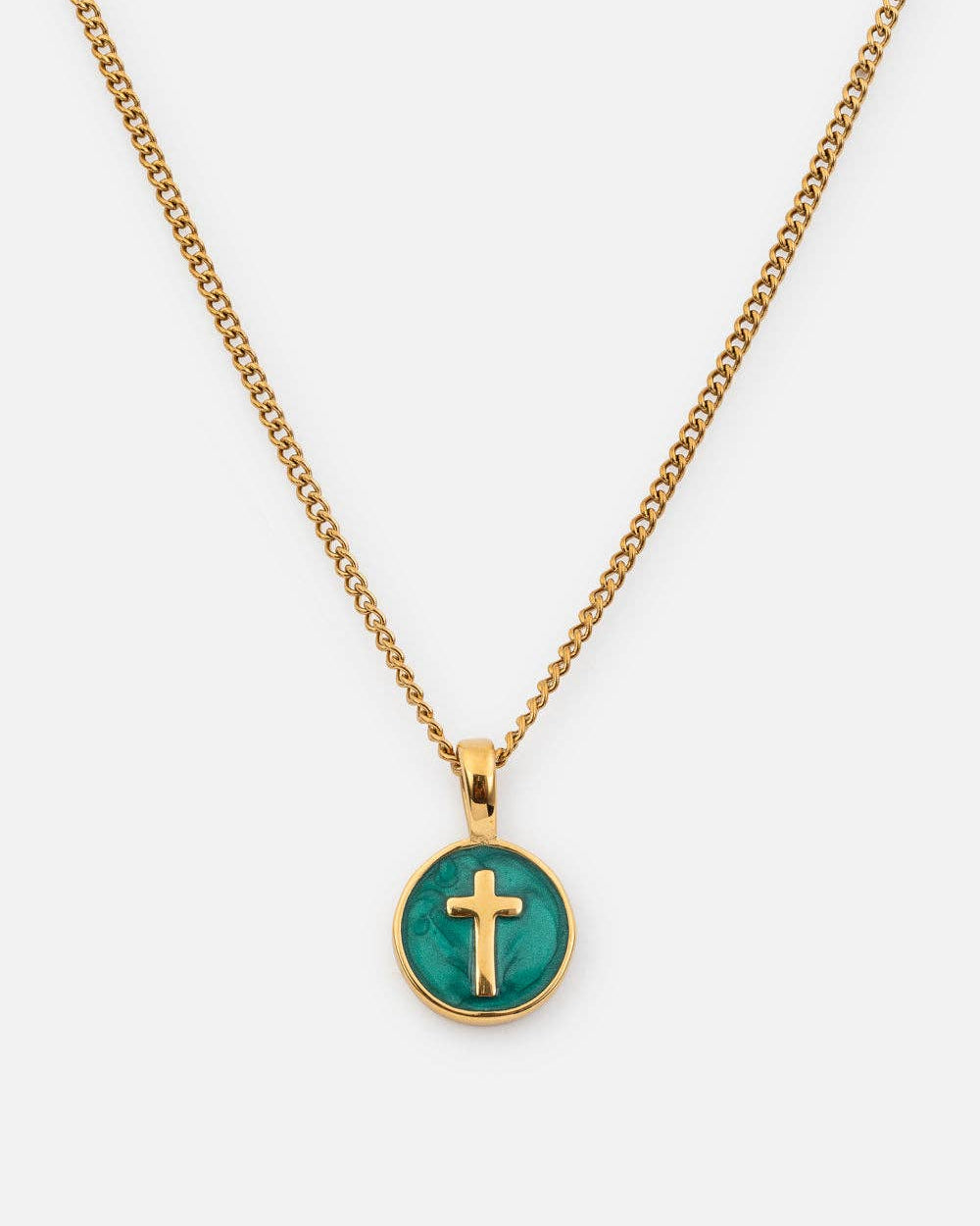 Gold necklace with a green pendant featuring a cross on a white background