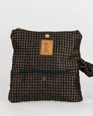 A small black and brown checkered fabric pouch with a wrist strap, a front zipper pocket, and a tan leather brand patch on a white background.