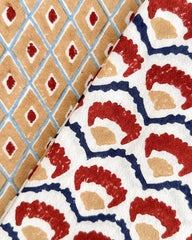 Two folded fabrics with distinct patterns shown side-by-side. The left fabric features a tan and light blue diamond lattice pattern with red diamond accents.