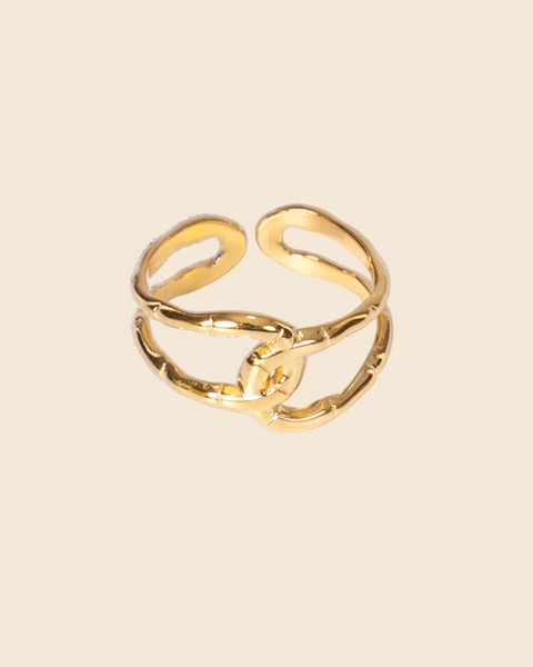 A gold-toned adjustable ring with a textured, organic wavy design, photographed on a clean white background.