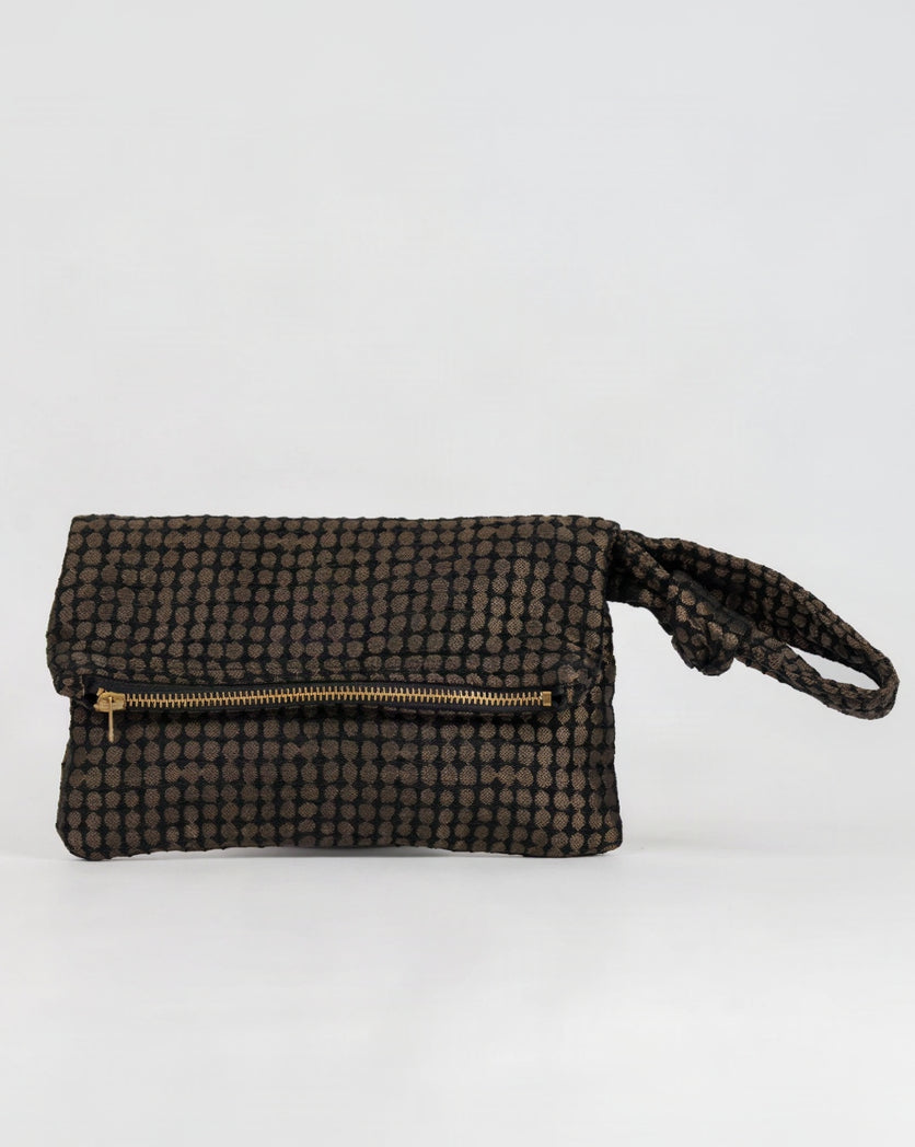 A small wristlet clutch bag with a black and brown checkered pattern, featuring a gold zipper and a matching wrist strap, set against a plain white background.