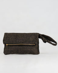 A small wristlet clutch bag with a black and brown checkered pattern, featuring a gold zipper and a matching wrist strap, set against a plain white background.