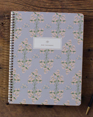 Notebook with floral pattern on a wooden surface