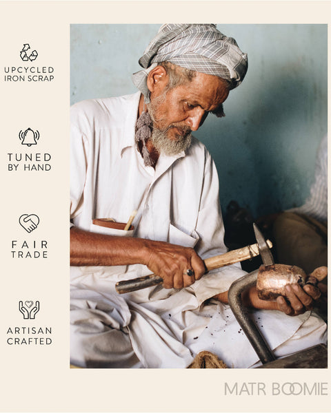 Man working with tools, surrounded by 'upcycled iron scrap', 'tuned by hand', 'fair trade', and 'artisan crafted' labels, with 'Matr Boomie' branding.