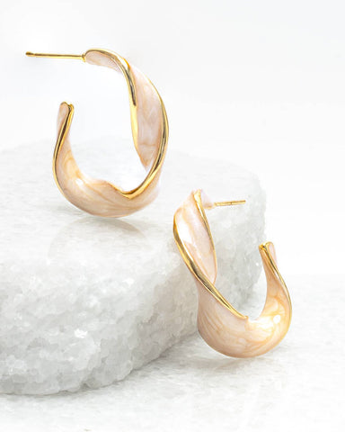 Our Twist Hoops are classic elegance with a twist! The 14K plated gold p...