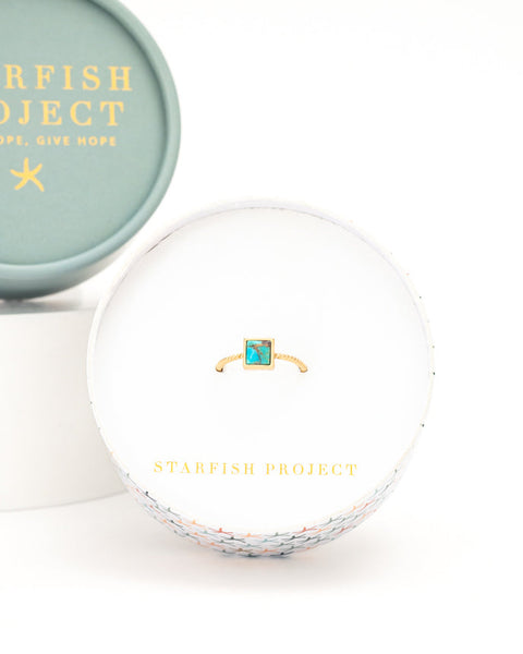 Starfish Project jewelry box with a ring inside on a white background