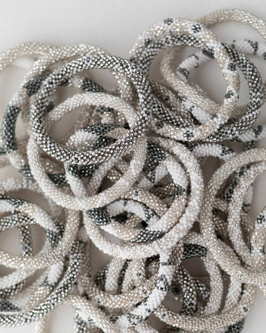 Our Sterling Roll-On Bracelets blend silvery grey, soft cream, and charc...
