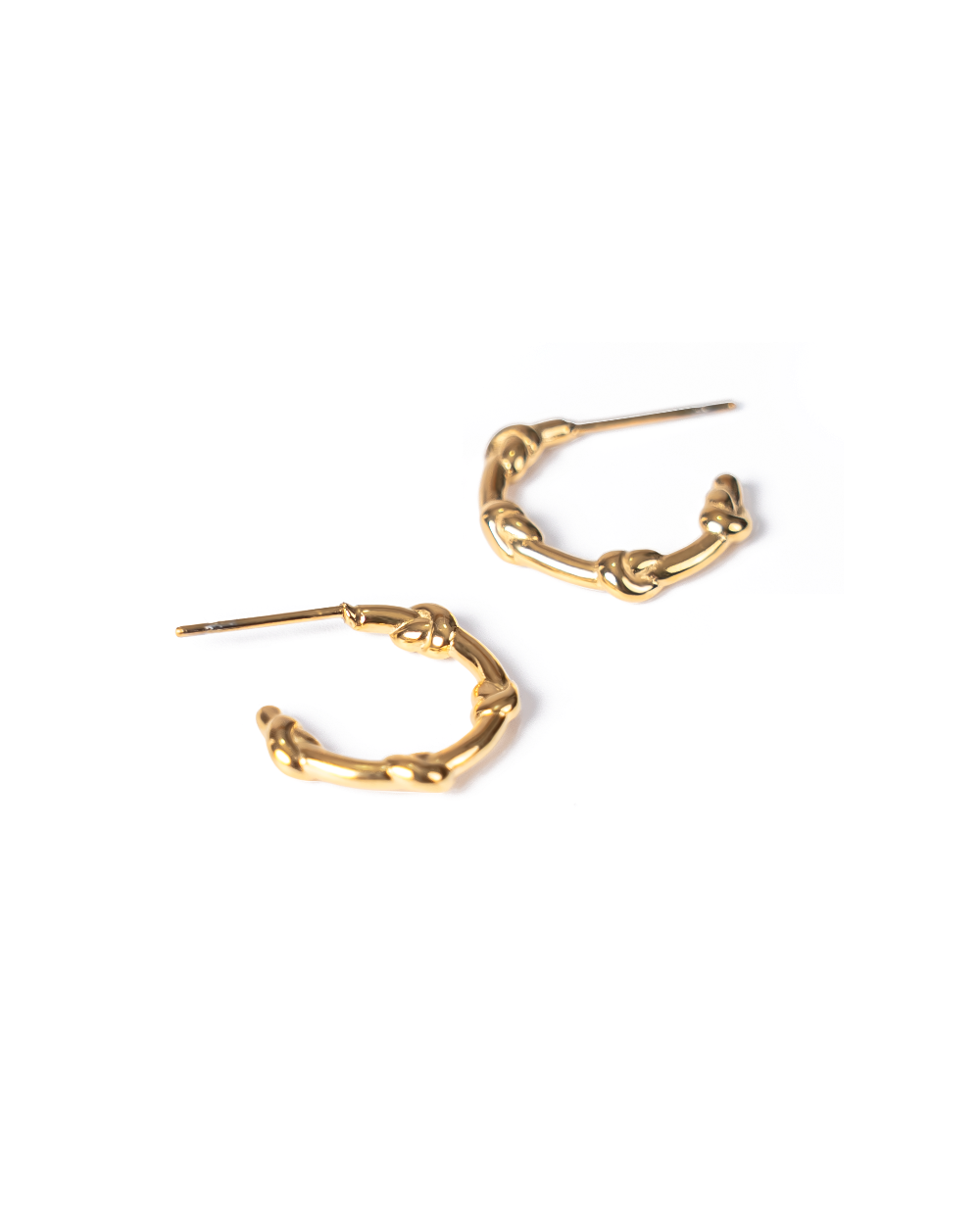 A pair of gold-toned huggie hoop earrings with a textured, knotted organic design, shown on a plain white background.