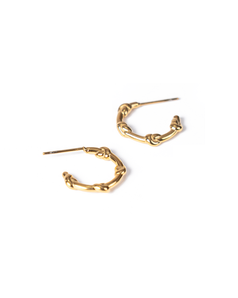 A pair of gold-toned huggie hoop earrings with a textured, knotted organic design, shown on a plain white background.