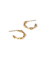 A pair of gold-toned huggie hoop earrings with a textured, knotted organic design, shown on a plain white background.