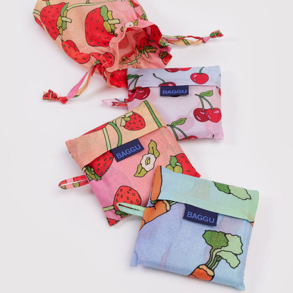 Set of colorful drawstring bags with fruit patterns on a white background