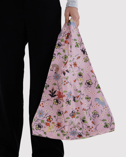 Person holding a floral-patterned bag against a white background