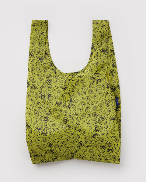 A reusable fabric shopping bag with a yellow-green and black paisley pattern, shown against a plain light gray background.
