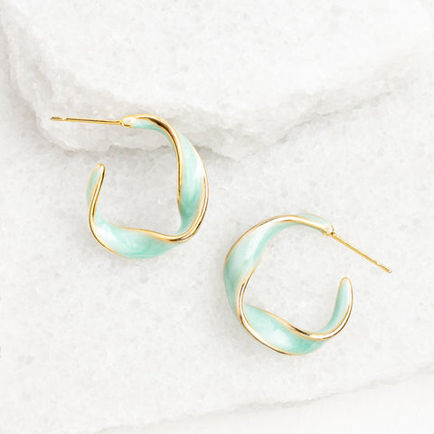 Our Twist Hoops are classic elegance with a twist! The 14K plated gold p...