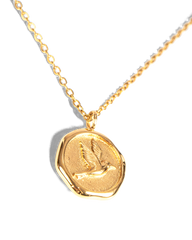 A gold necklace with a textured, irregularly shaped pendant featuring an embossed bird, displayed on a clean white background.