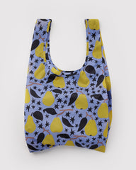 A reusable fabric shopping bag with a pattern of yellow pears, black leaves, and black stars on a dusty blue background, shown against a plain light gray background.