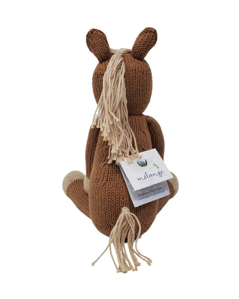 Knitted horse toy with a mane and a tag on a white background