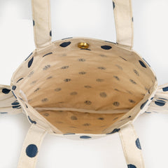 Polka dot bag with beige interior on a white background