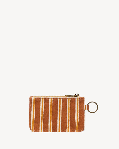 A small zippered pouch with vertical orange and cream stripes, featuring a gold-tone metal ring attachment, set against a solid off-white background.