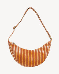 A crescent-shaped shoulder bag with a rust-orange and white vertical stripe pattern, featuring a matching adjustable strap, shown against a plain off-white background.