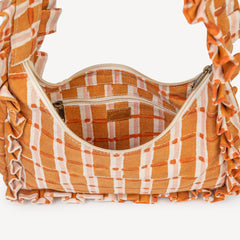 Plaid patterned bag with ruffled edges on a white background