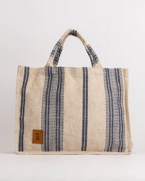 Beige tote bag with blue stripes and a handle on a white background
