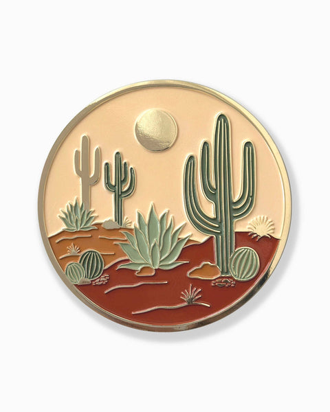 Round coaster with desert landscape design featuring cacti and a sun on a white background