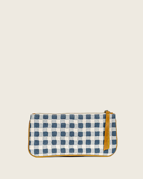 Checkered pouch with leather trim on a beige background