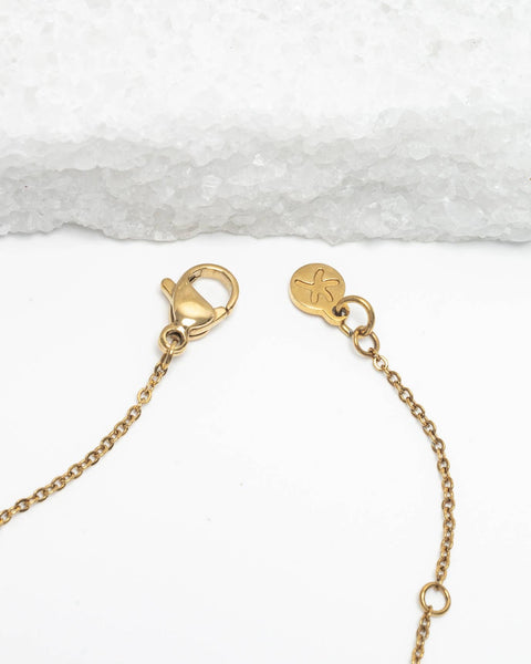 Gold necklace clasp on a white background