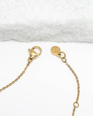 Gold necklace clasp on a white background