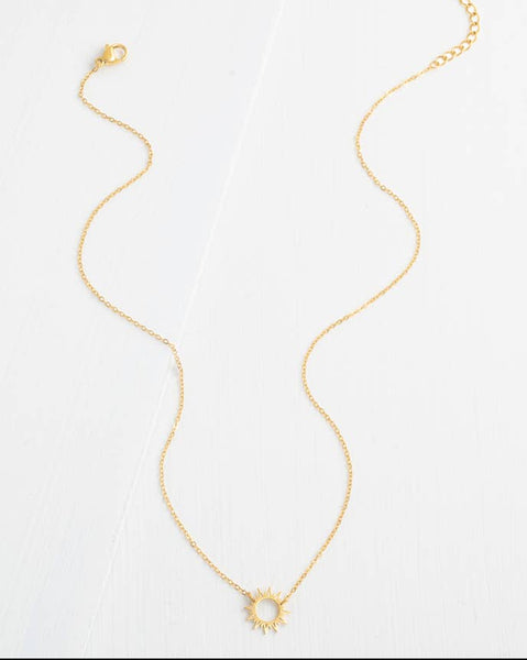 Gold necklace with a sun pendant on a white background
