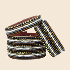 Stack of beaded bracelets on a light blue background