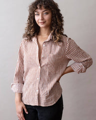 Woman wearing a striped shirt against a plain background