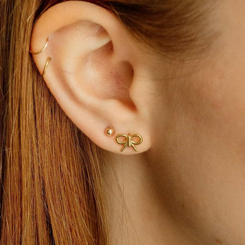 gold bow nap earrings