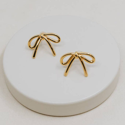 These adorable gold bow earrings were ethically made in Asia by survivor...