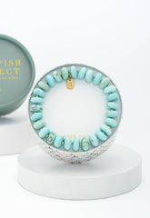 Turquoise beaded bracelet in a round box 